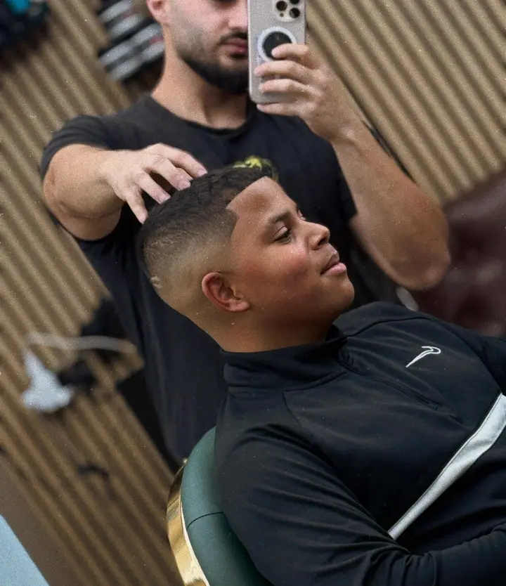 Ram filming a fresh skin fade on a young client
