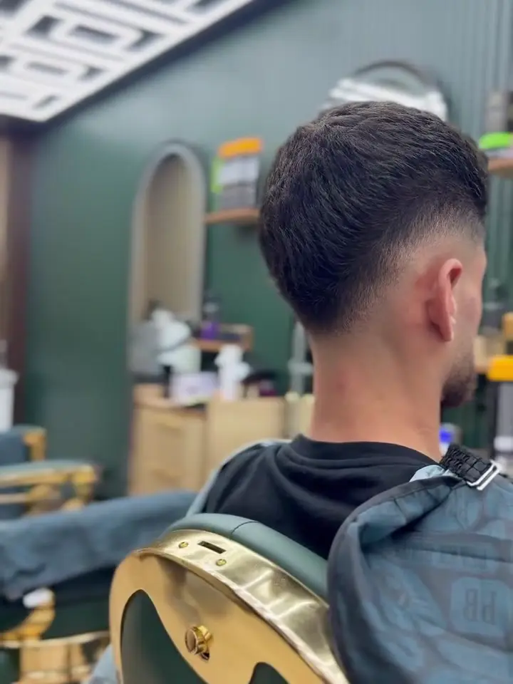 Mid fade blended into a textured top, seen from behind