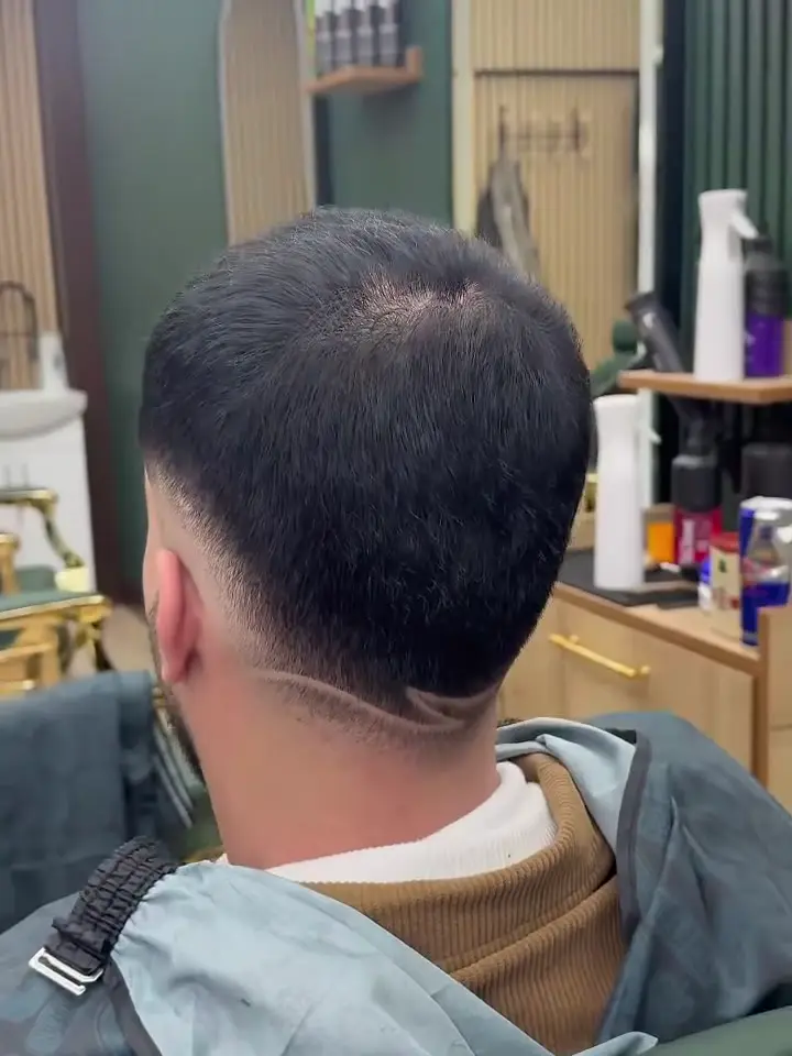 Freehand line design shaved into the back of a fade